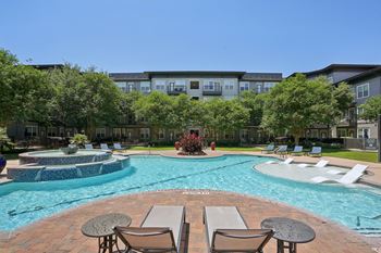 Resort style pool with tanning ledge and courtyard